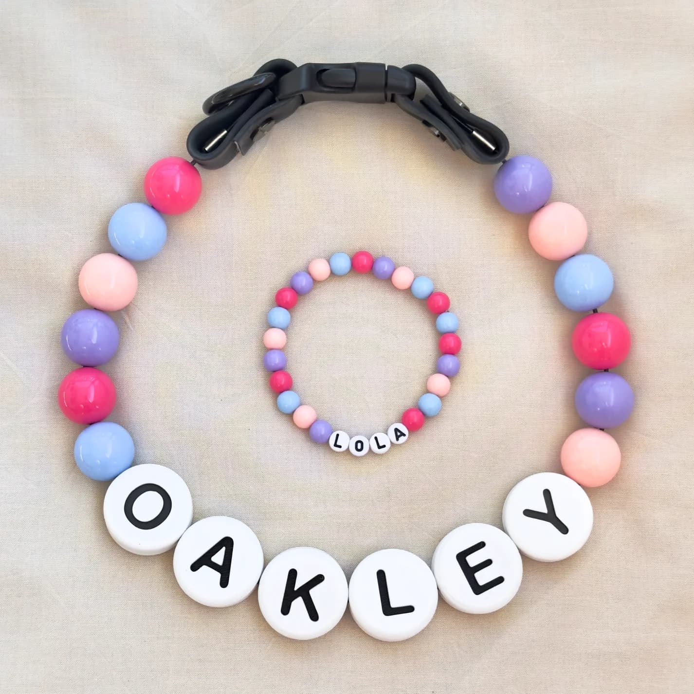 A pink and lavender beaded collar spelling OAKLEY with a matching bracelet